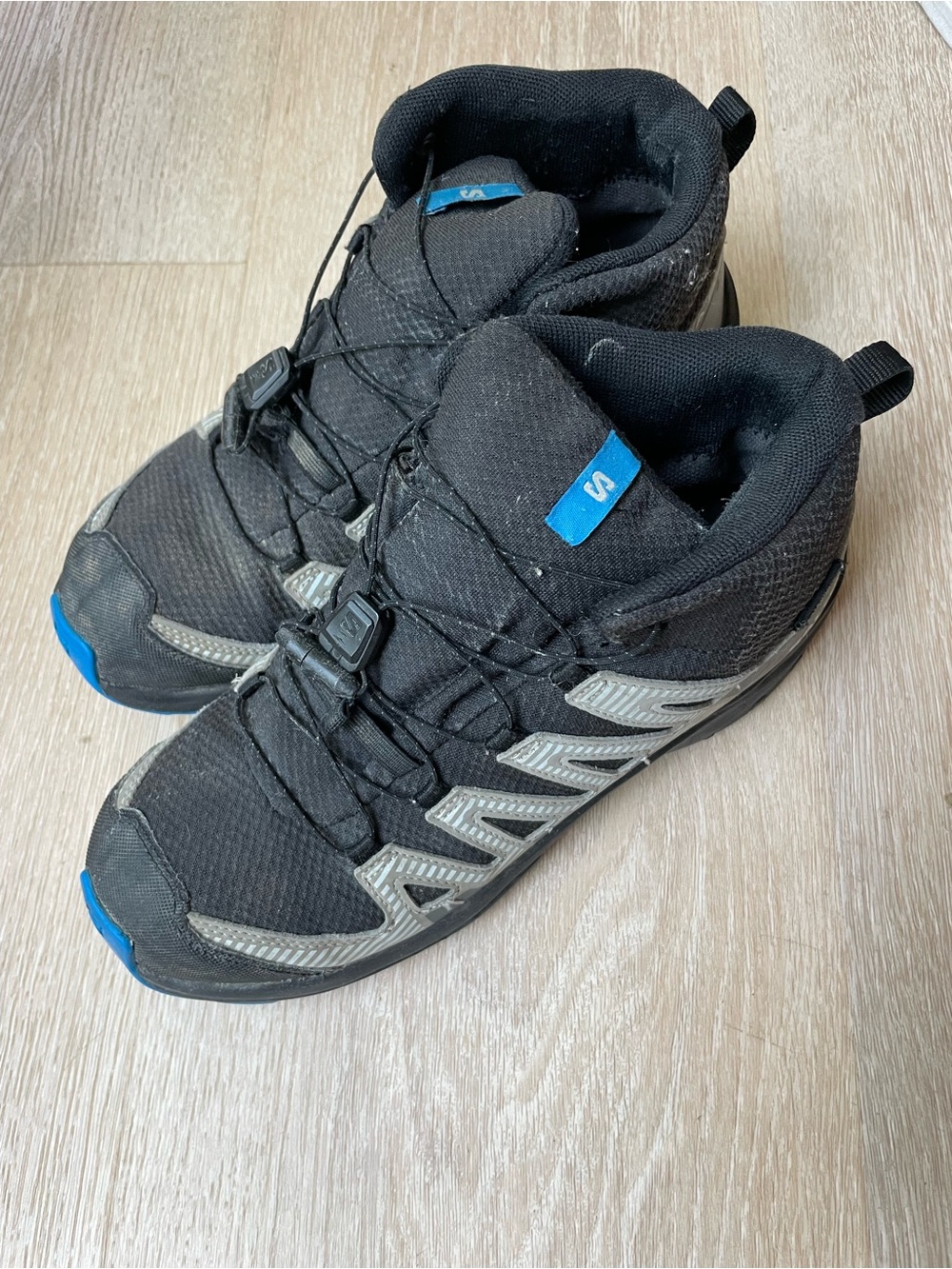 Salomon Black Trail Shoes with Blue Logo Tabs and Gray Overlays